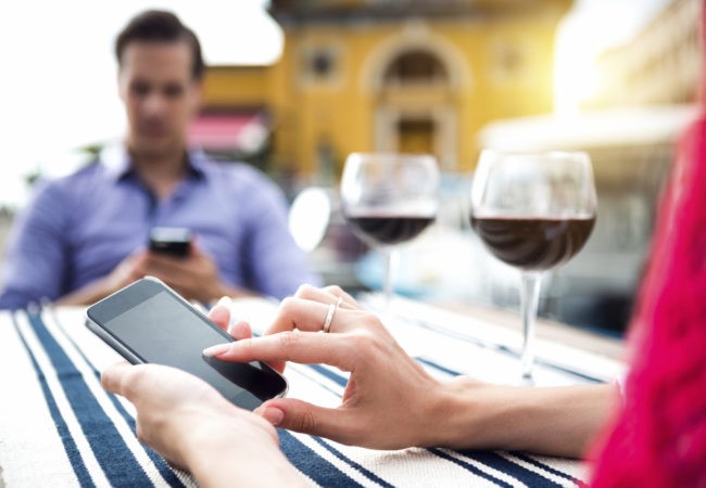 ouple Using Mobile Phone During Dinner